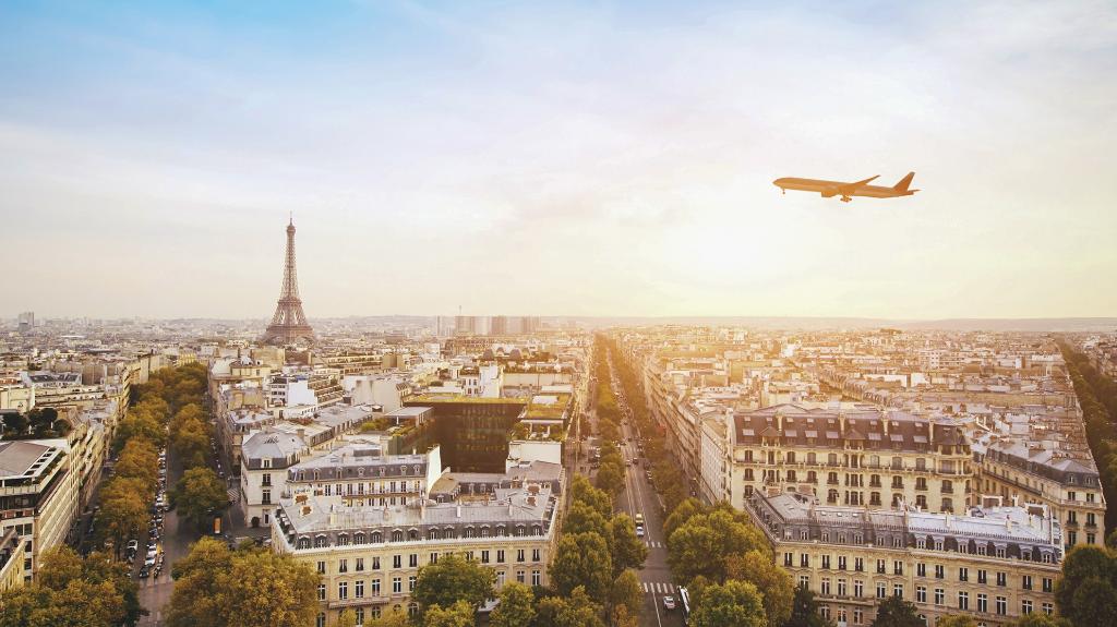 airplane-flying-over-paris-eiffel-tower
